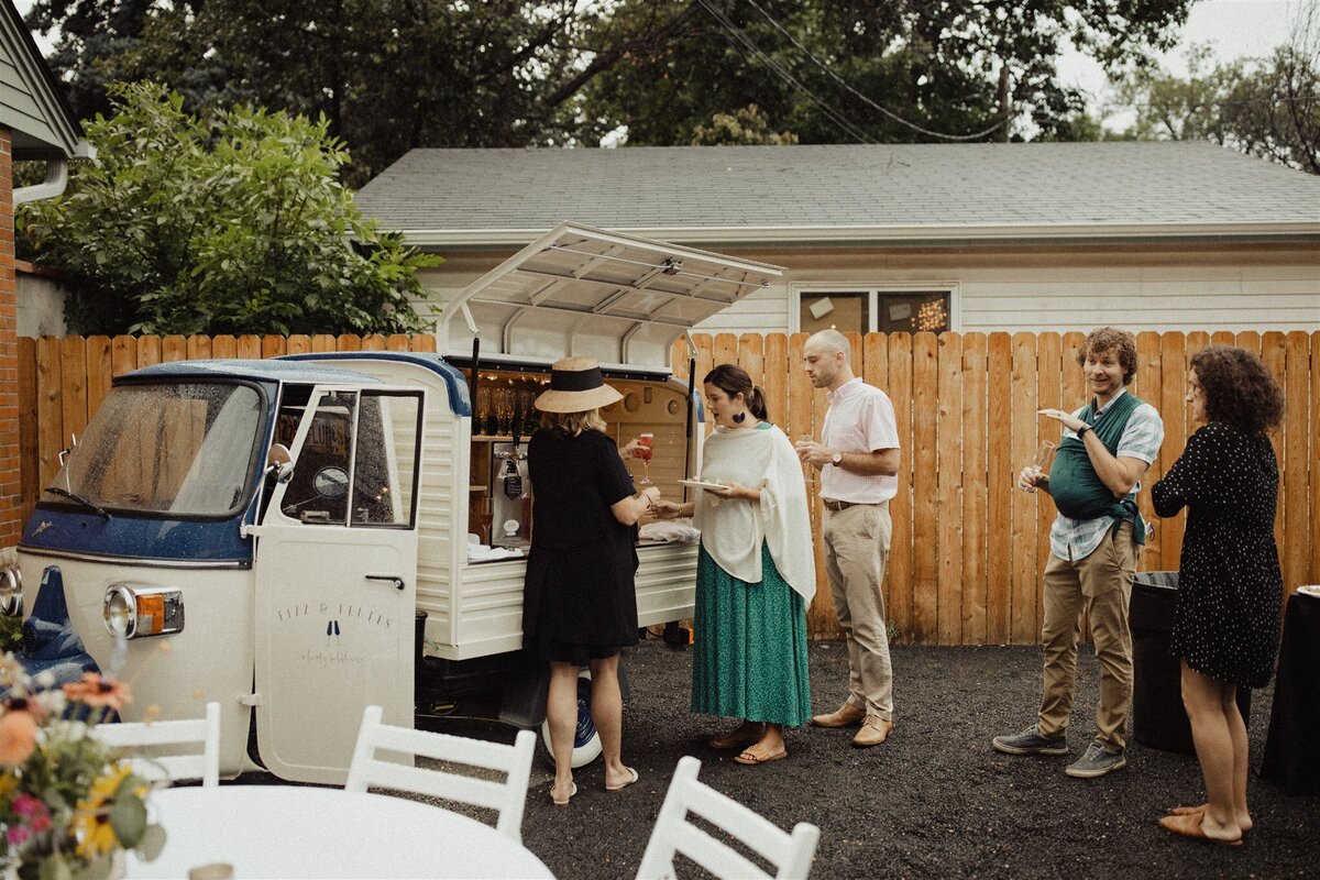 Guests eating from at food truck at rehearsal dinner at the Terry Guesthouse, a micro wedding venue at historic home in Longmont, Colorado