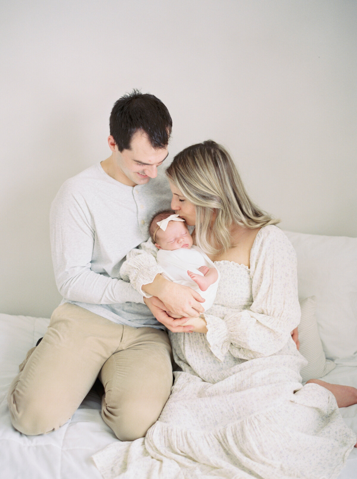 new parents in floral dress holding new baby photographer milwaukee wi  Talia Laird Photography