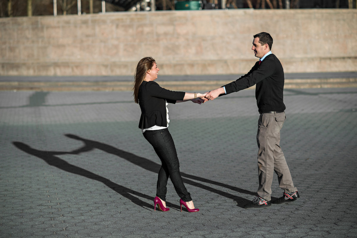 A man and woman dance in the park in downtown NYC.