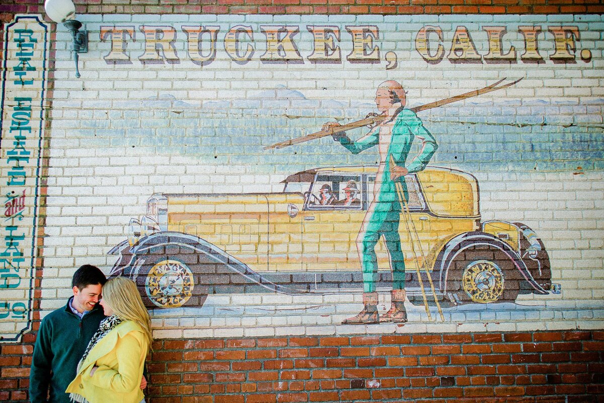couple during engagement  session in Truckee in front of Truckee mural