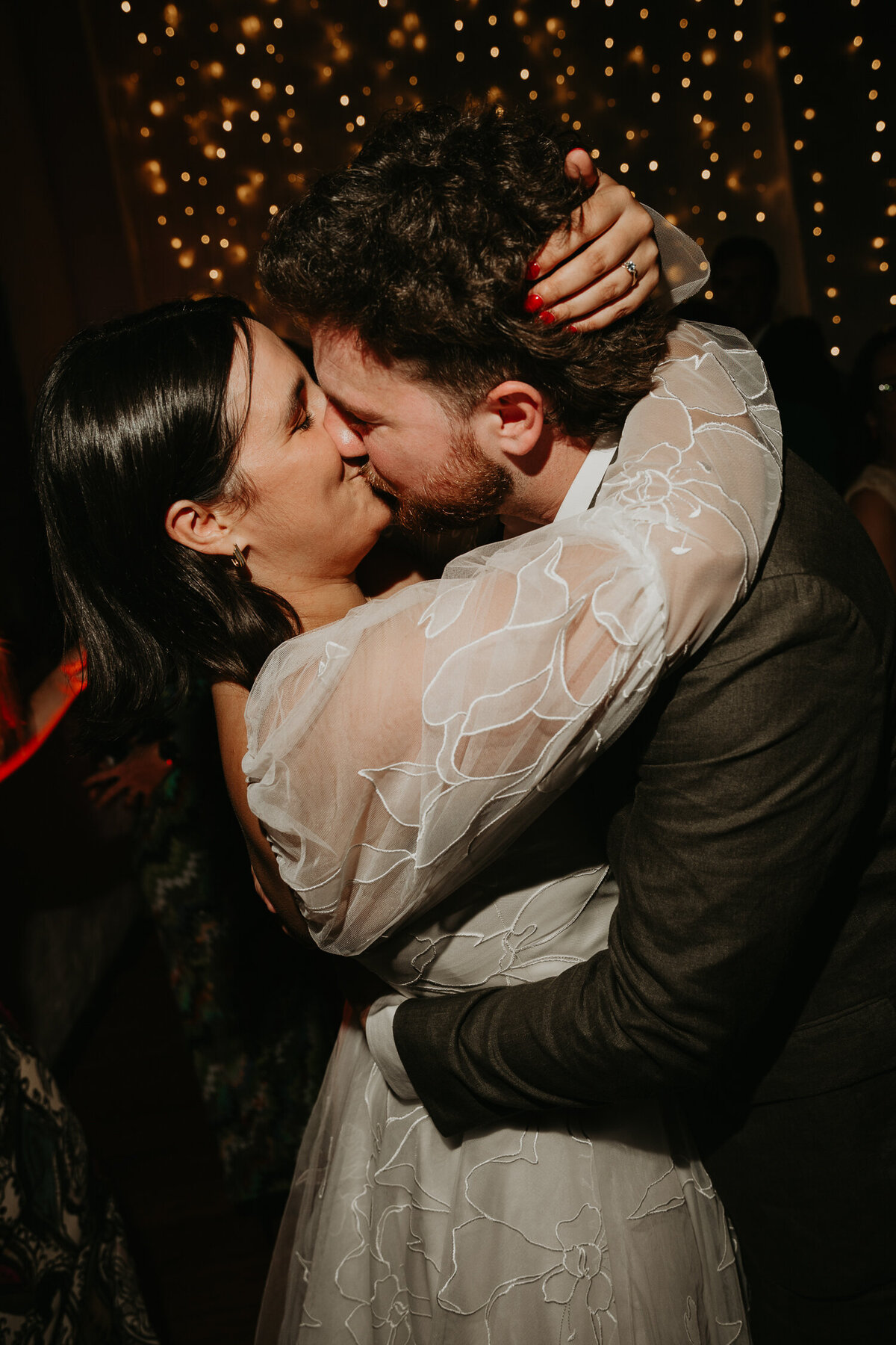 A Bride and Groom kiss on the dance floor at their wedding at Paintworks in Bristol. 