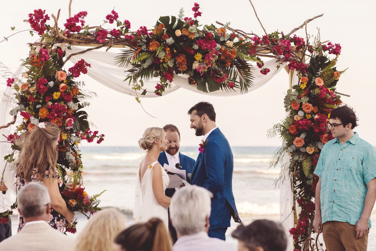 Bride and groom under arch at Blue Venado Seaside Riviera Maya wedding