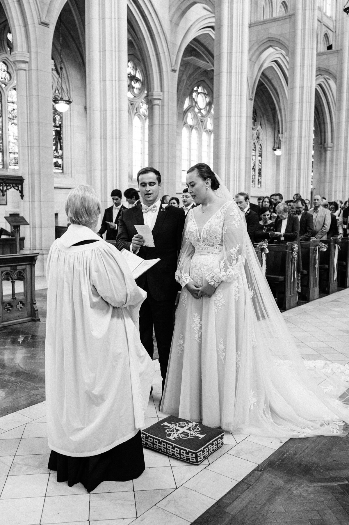 cathedral wedding with bride and groom standing in front of minister