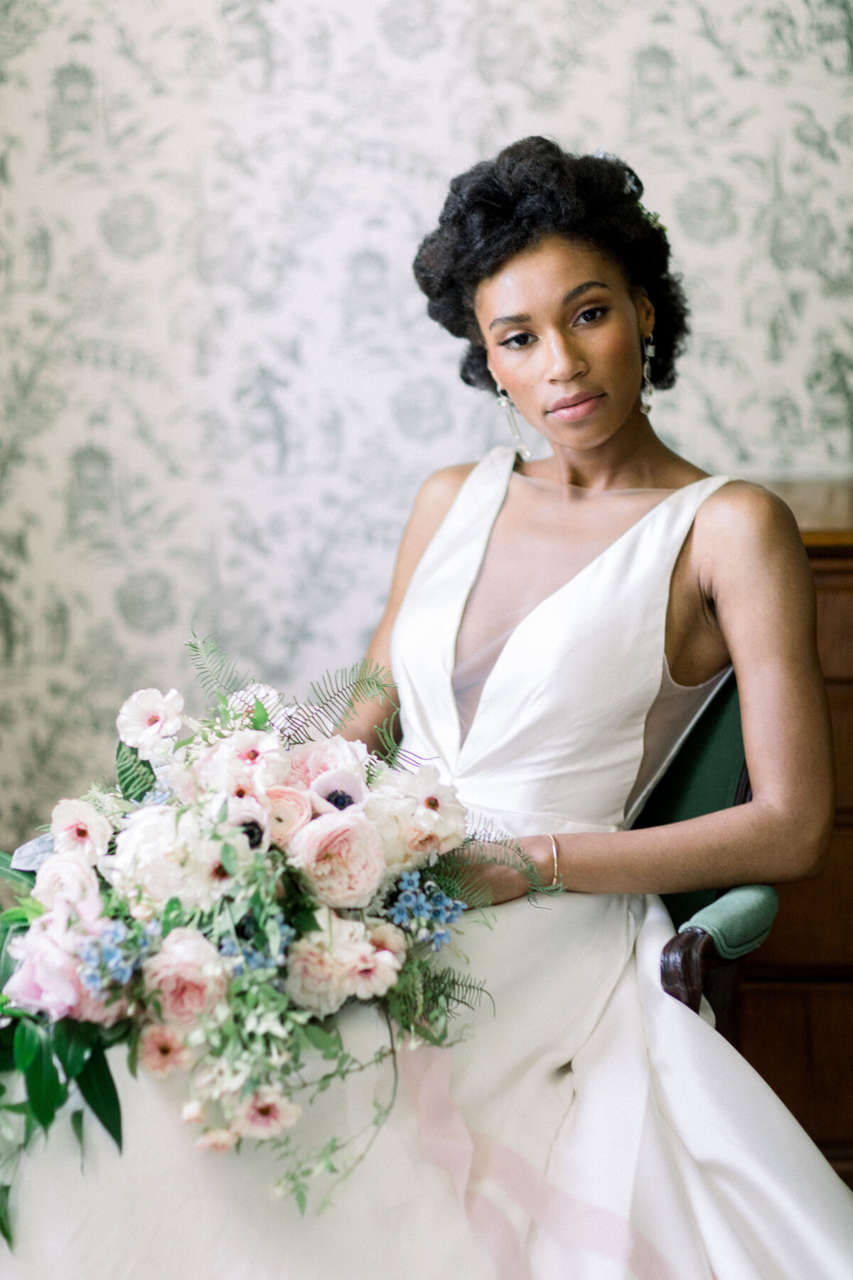 bride sitting holding bouquet