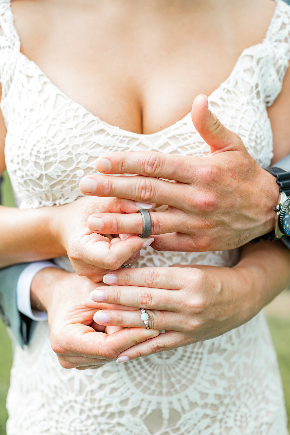 Ring shot with both bride and grooms hands.