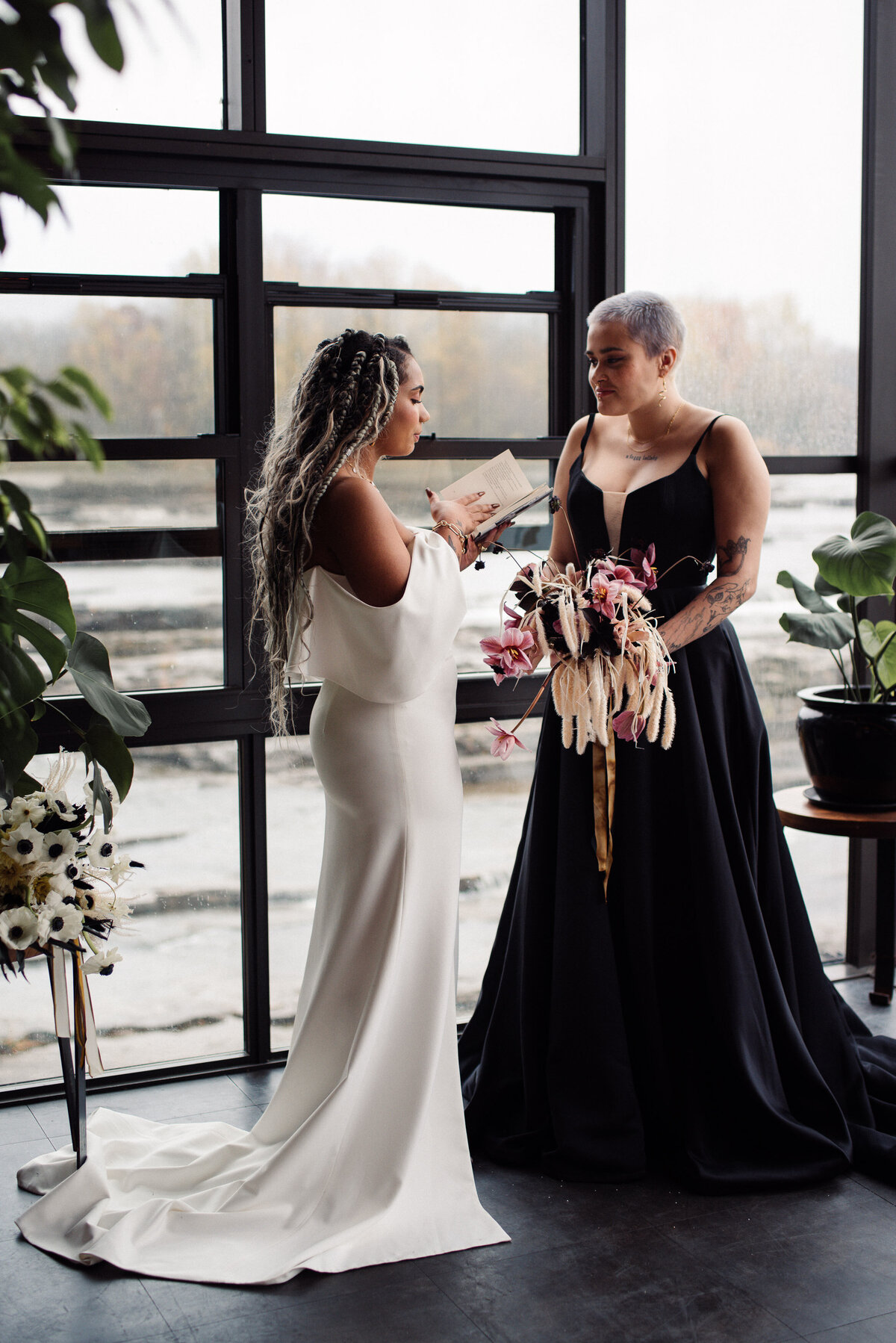 Modern and chic wedding with Black wedding dress with flowers by Nectar and Root. At waterworks in Winooski, VT. Wedding planned by Jaclyn Watson Events.