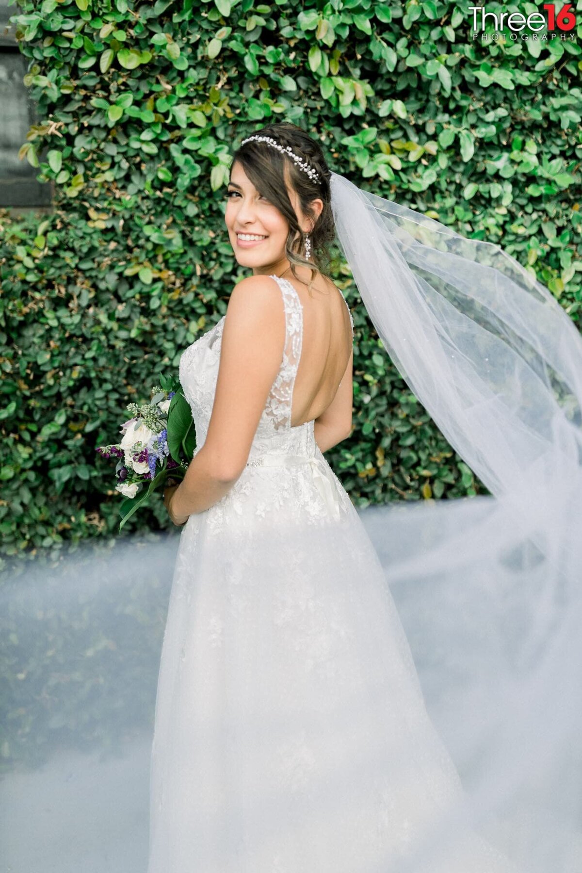 Gorgeous Bride poses as her veil flows in the wind