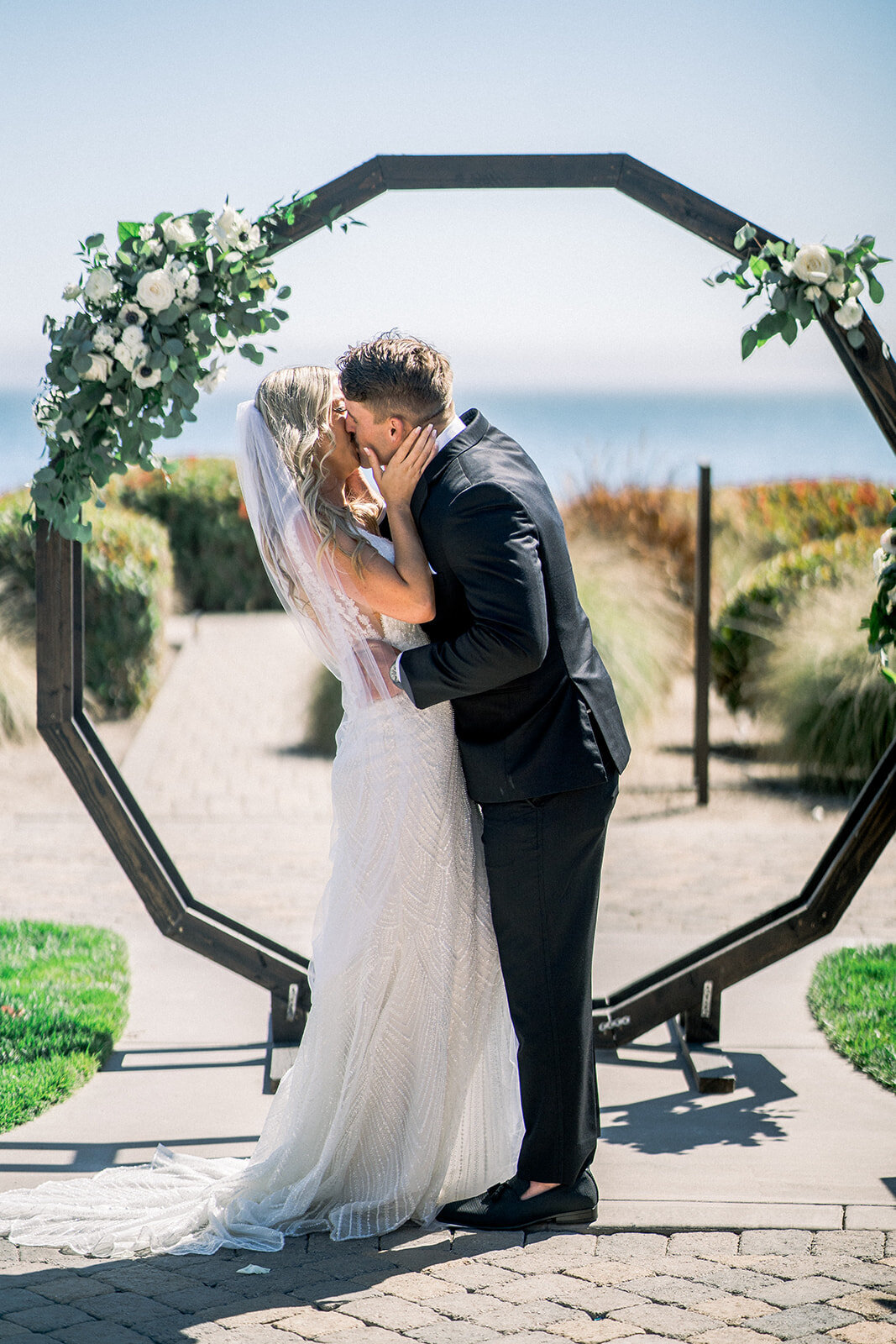 wedding ceremony kiss at Dolphin Bay Resort in Pismo Beach, CA