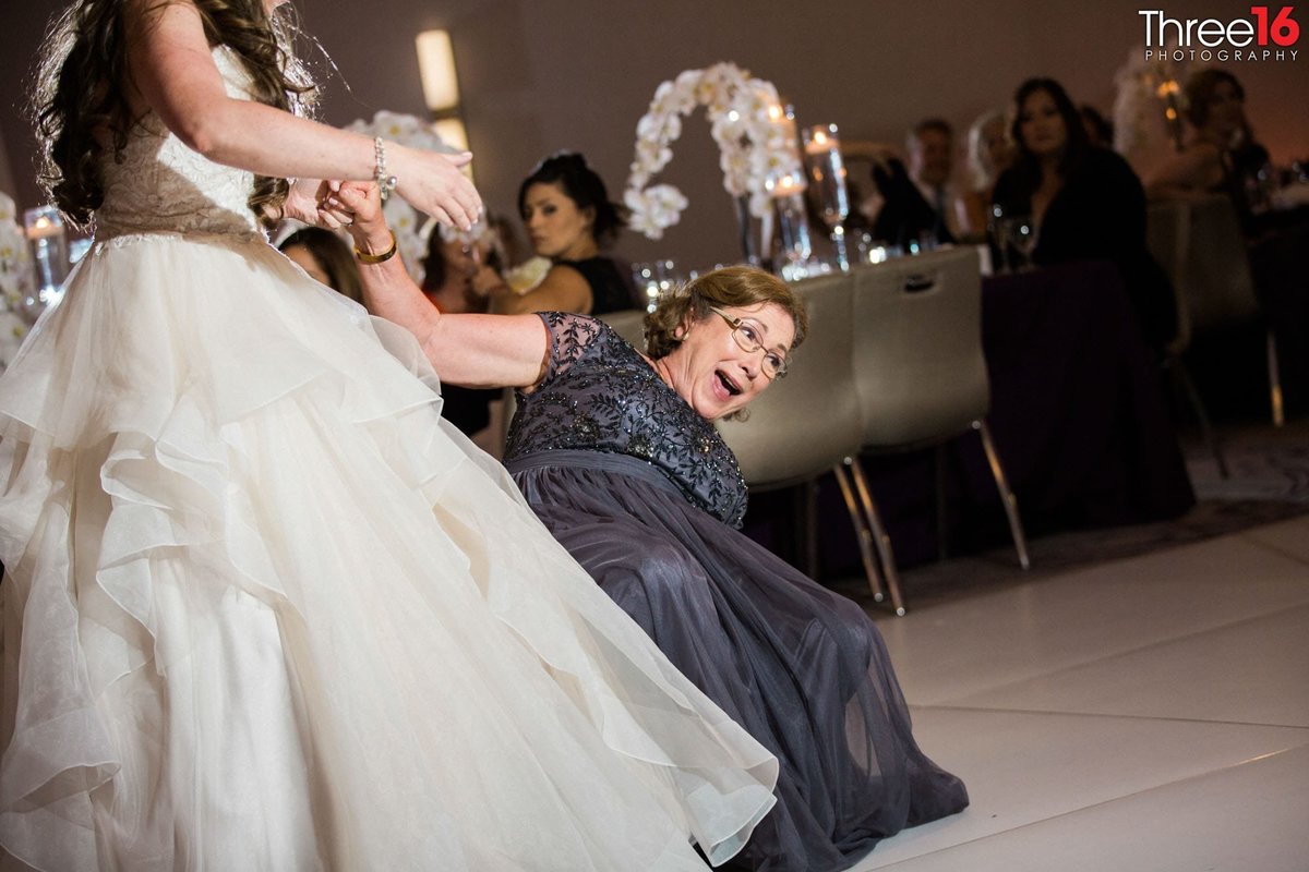 Woman falling over during wedding reception
