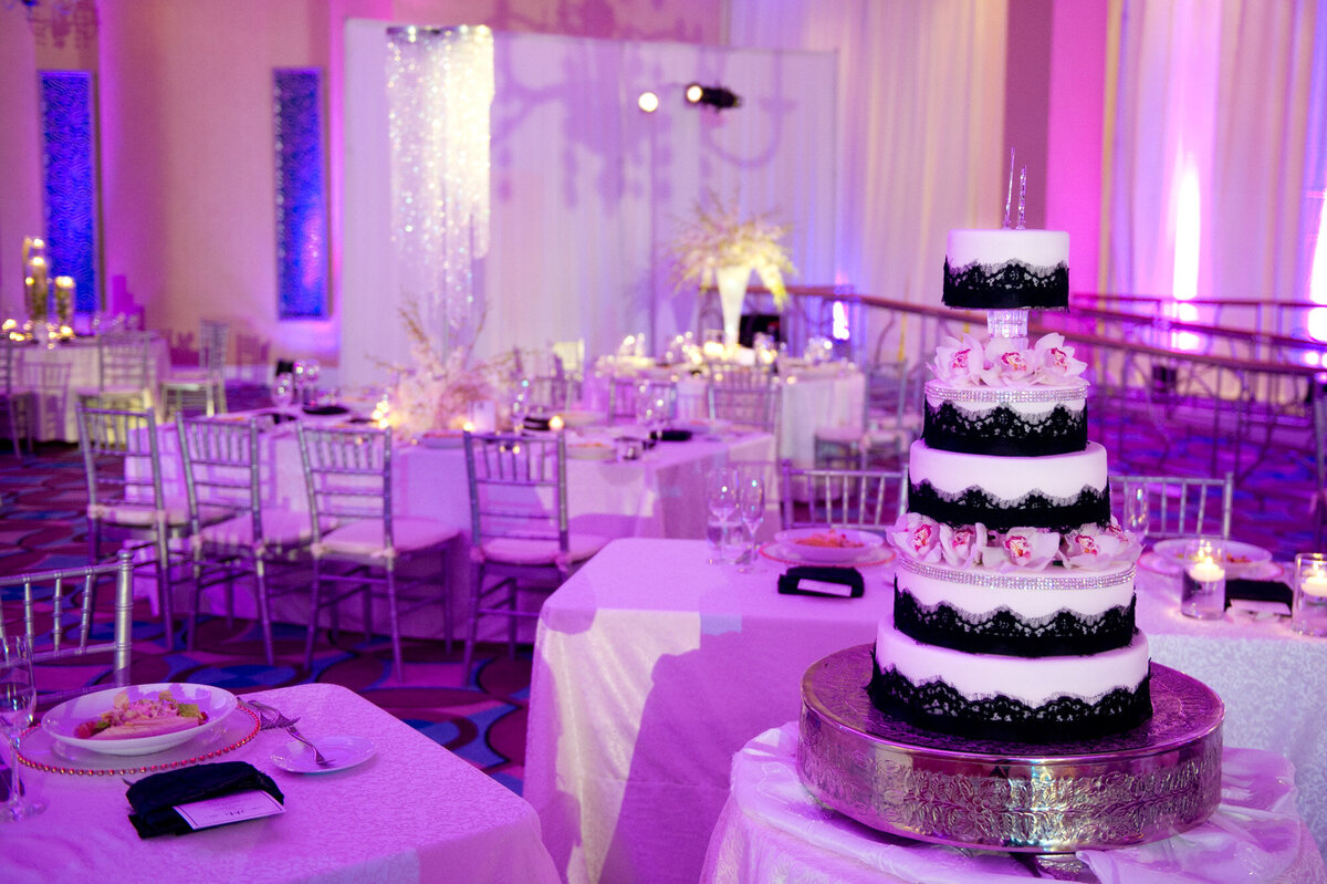 Wedding reception site with tables and chairs and the luxurious wedding five tier cake
