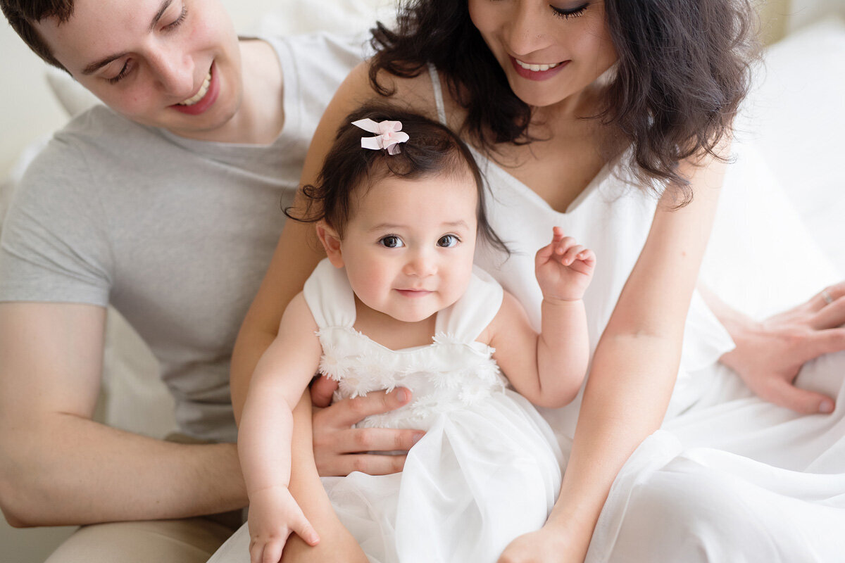 Family session of little girl and her parents in home