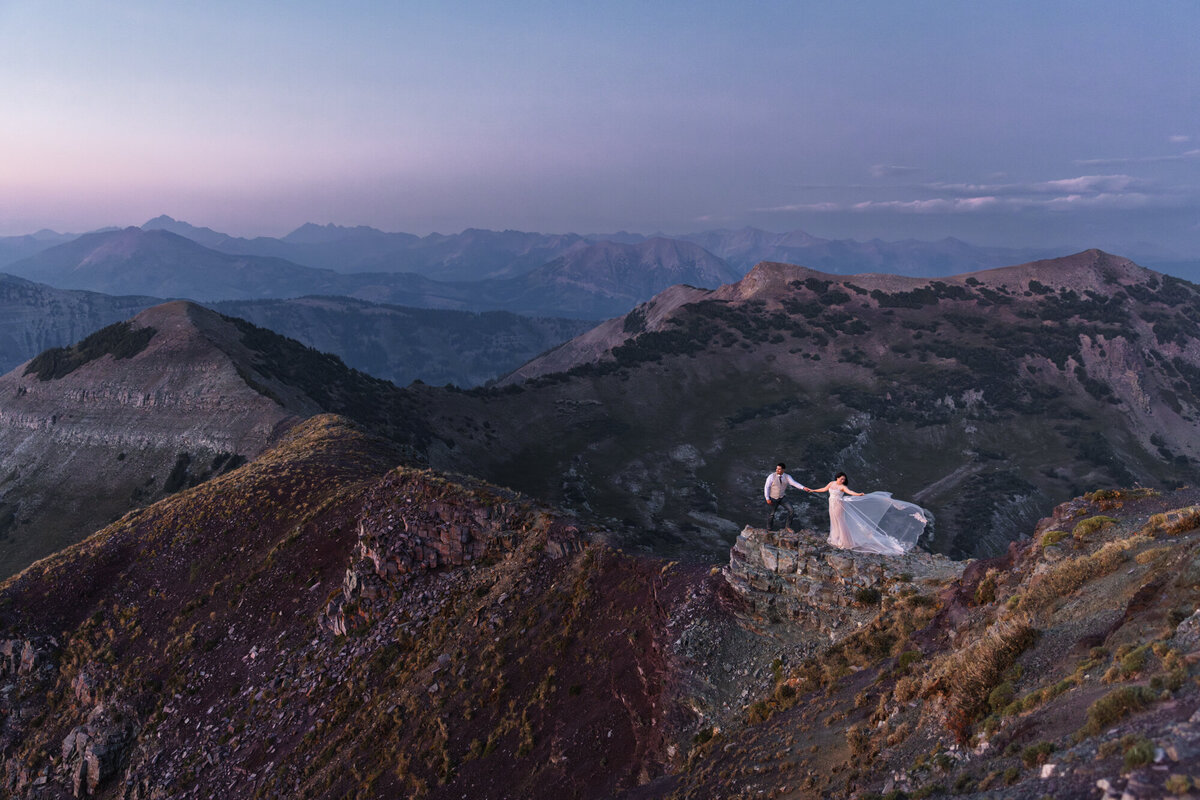 bride and groom walking near ocean