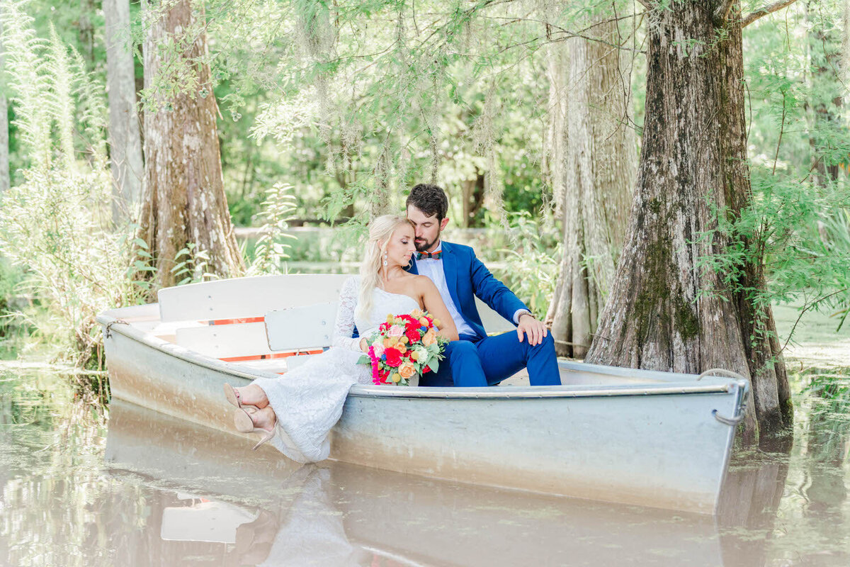 Bride and Groom floating in a river paddle boat