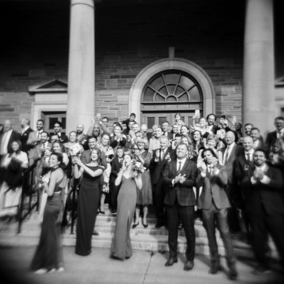 Wedding guests outside church in Halifax, Nova Scotia with party poppers