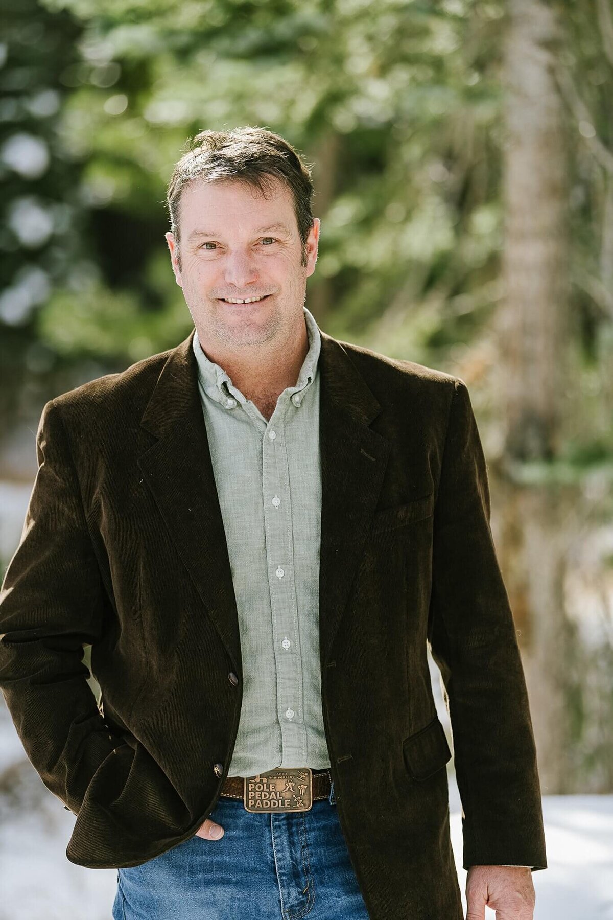 man in casual blazer smiling at camera headshot as head of school