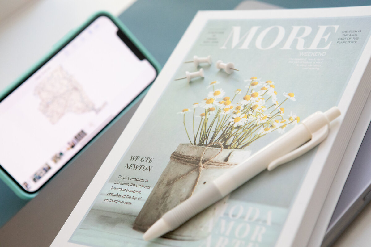 Still life of magazines with pen and smartphone New York branding photographer Milestone Images