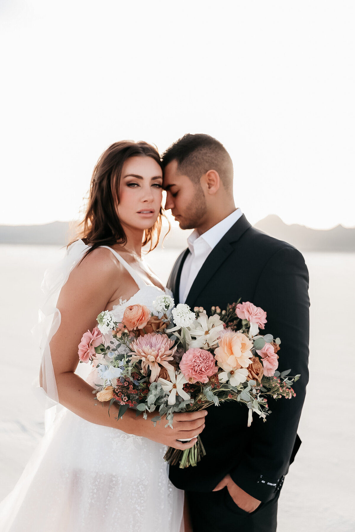 Salt Flats Utah editorial shoot with bride and groom and colorful bouquet.