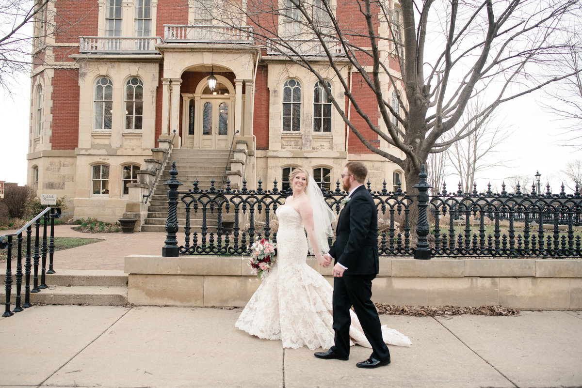 A married couple stroll together in front of a downtown building Kankakee IL