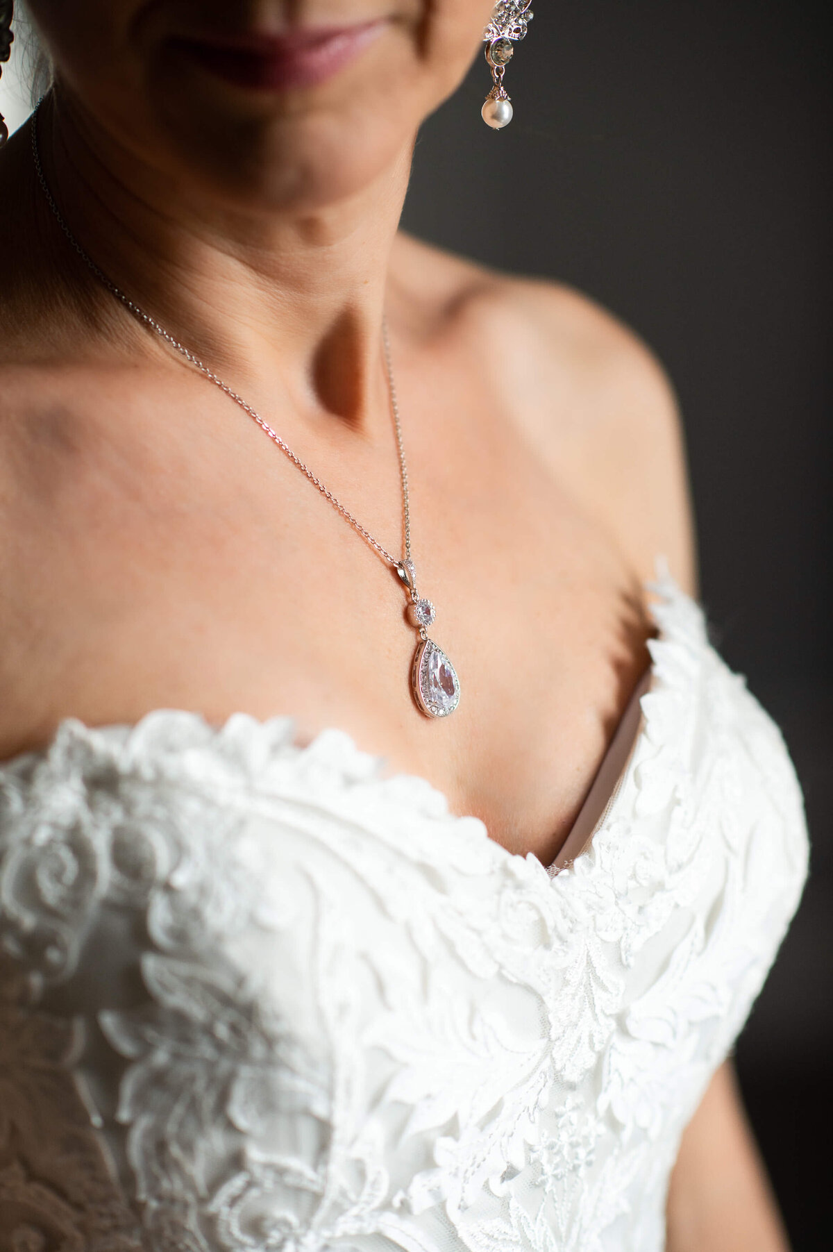 Ottawa wedding photography showing the intricate applique details of the bride's wedding gown and necklace