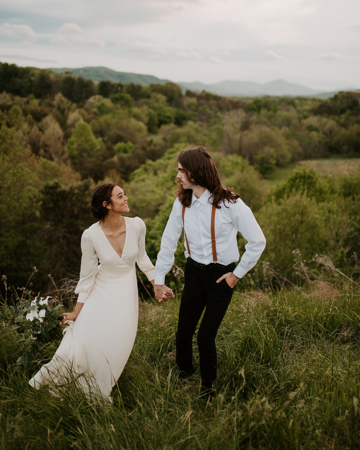 Walking through tall grass in the field after their ceremony on the parkway in North Carolina.