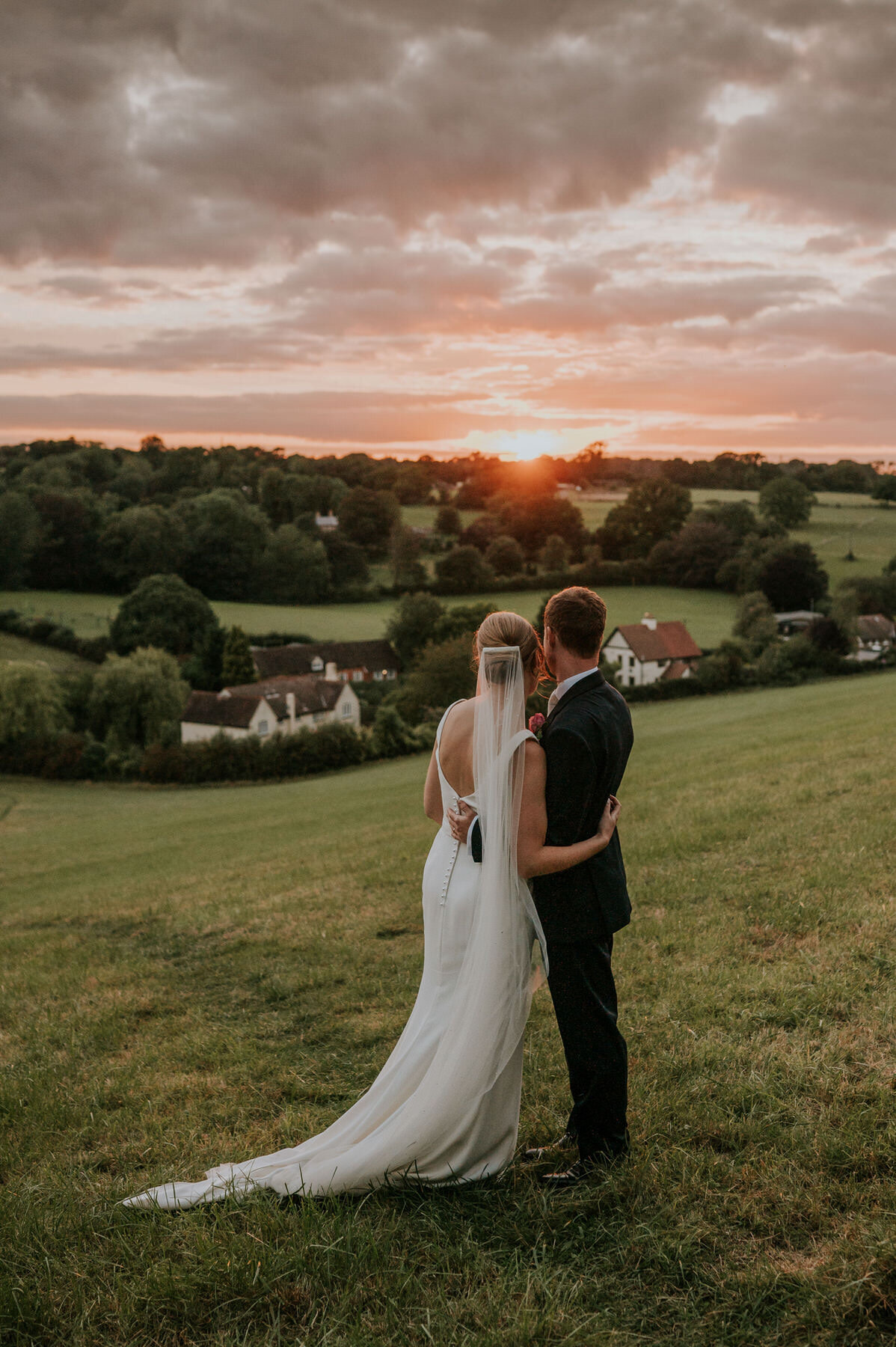 bride and groom watching the beautiful sunset