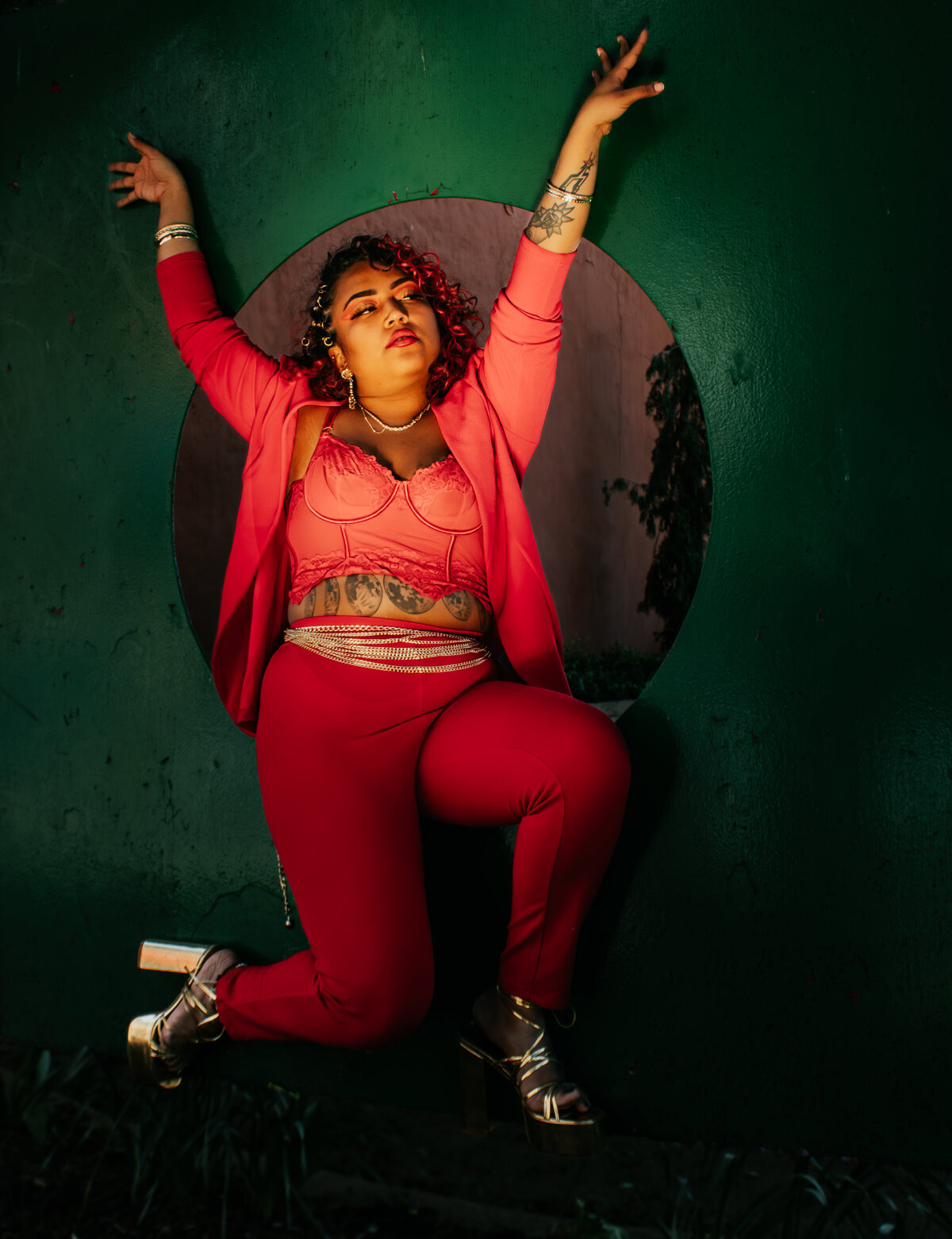 creative portraits with women in red 2 piece outfit in old town Lansing Michigan
