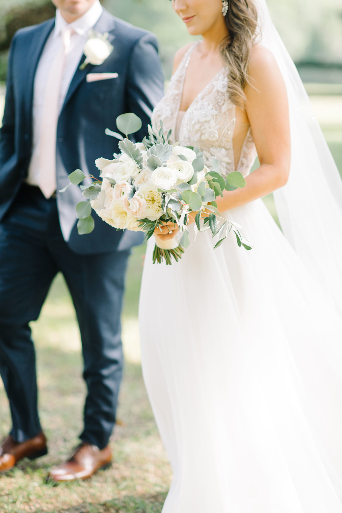 Bride with blush ivory greenery bouquet with Groom in Navy blue suit