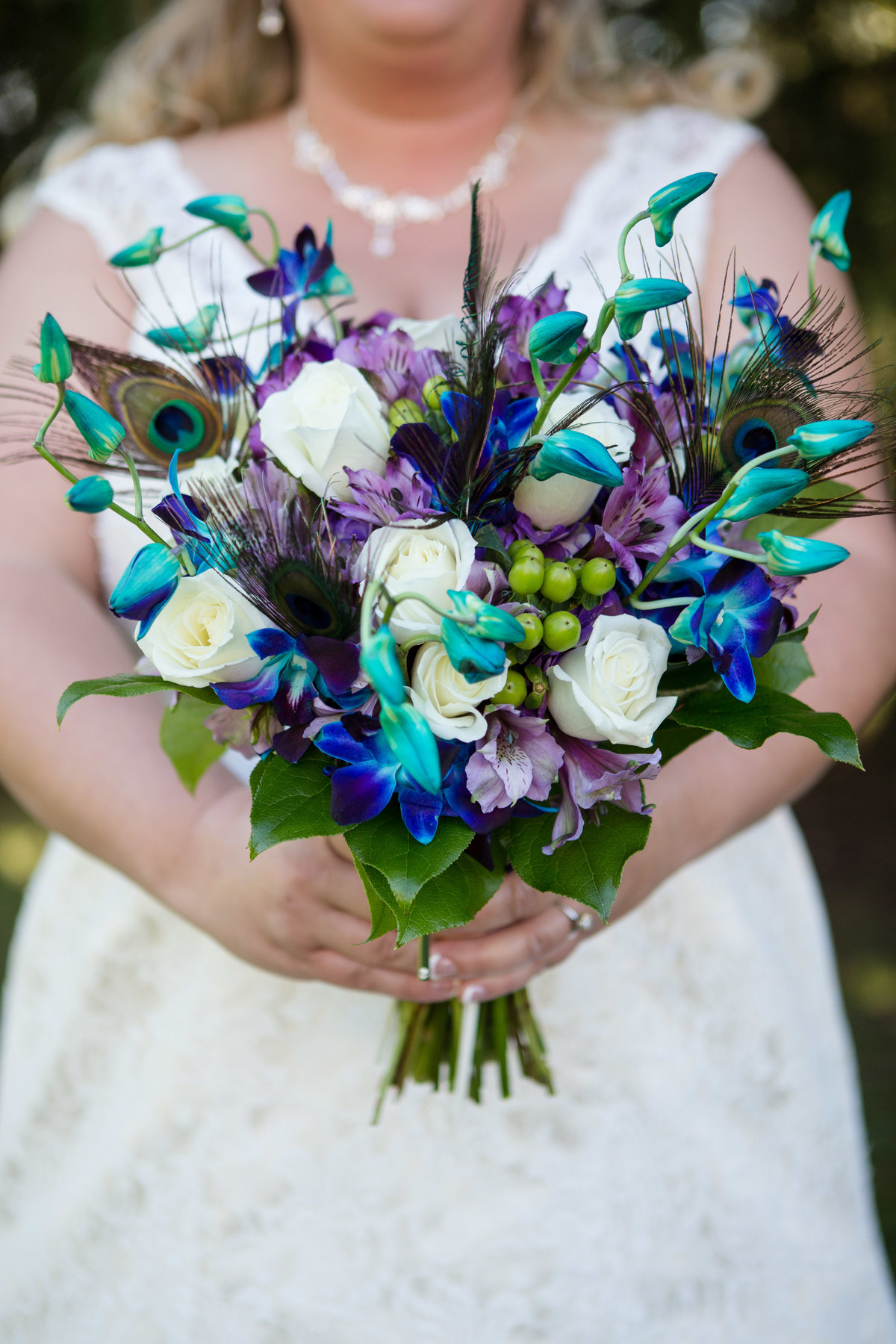 colorful peacock feather and flower bouquet
