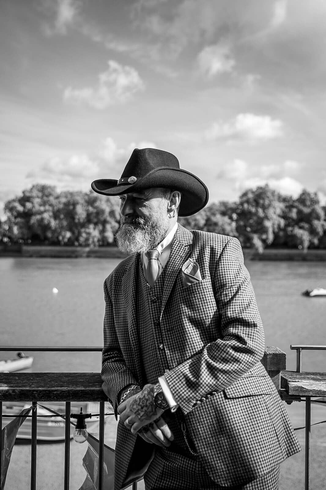 Man wearing black cowboy hat on balcony of Thames Rowing Club