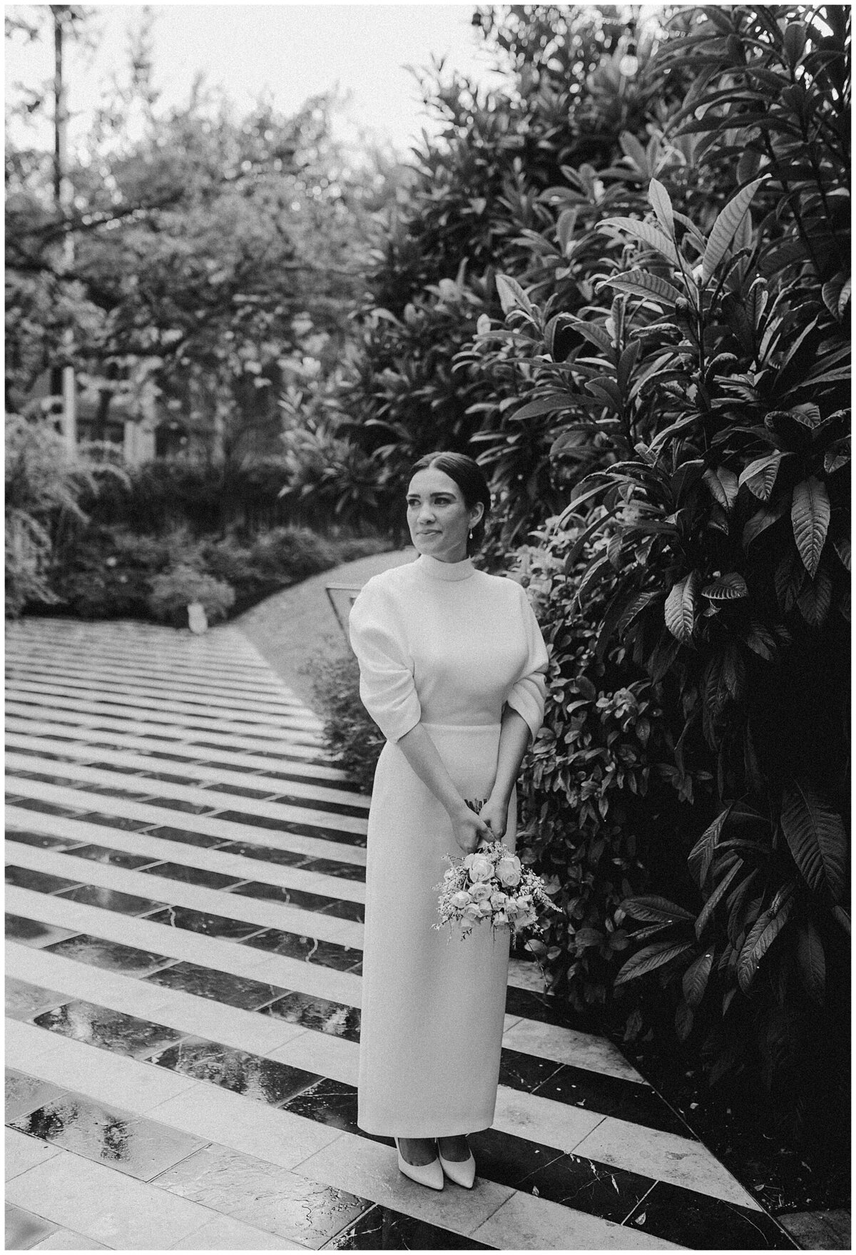 Bride standing on black and white striped flooring in the grounds of Hotel Saint Cecilia Austin