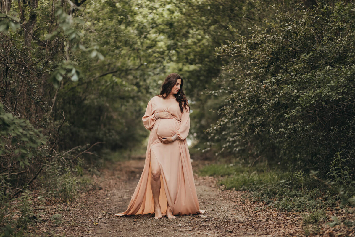 horizontal image of mother holding her belly for ally's photography