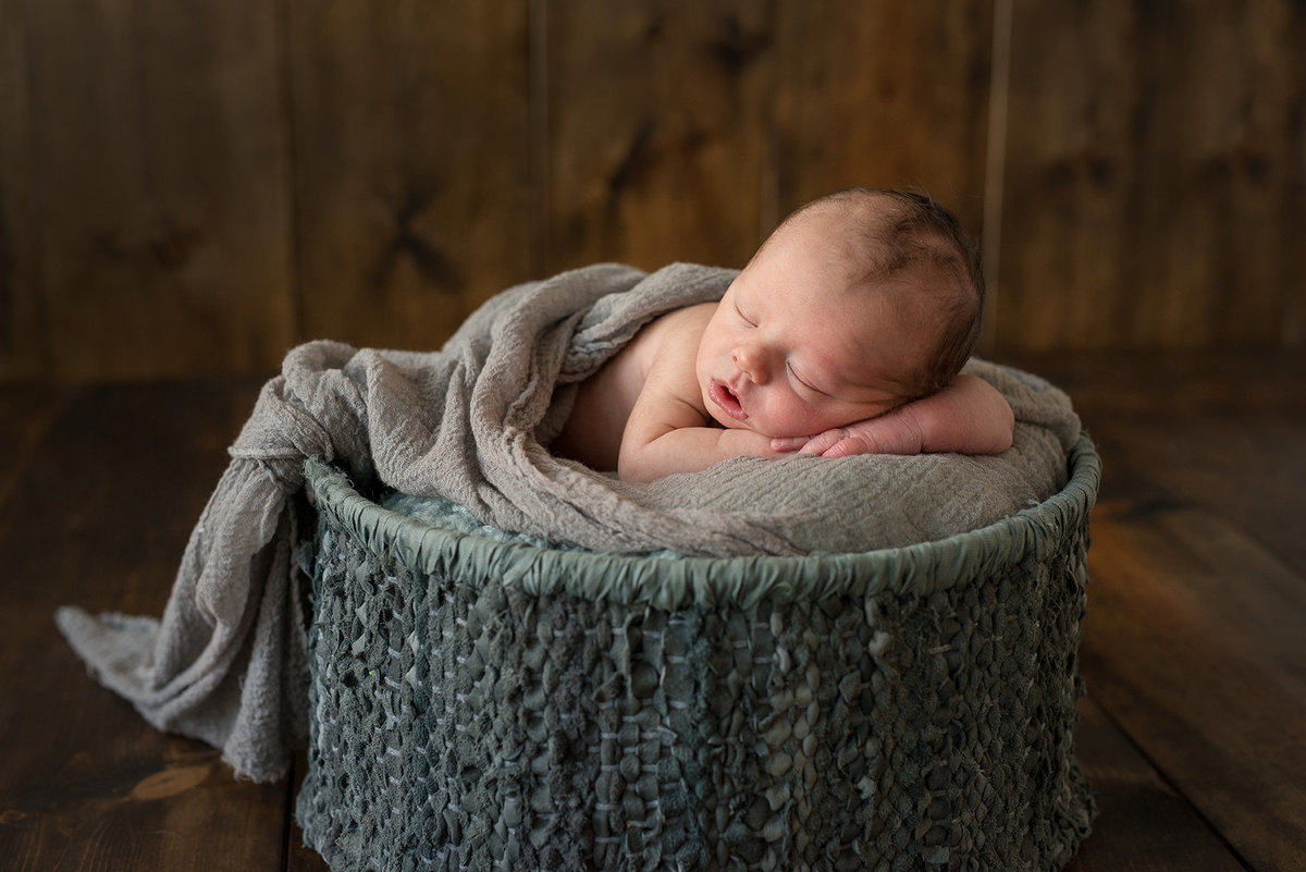 a baby boy in a basket