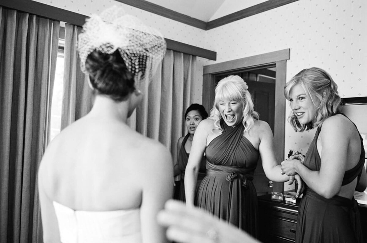 Bride reveal reaction of bride maid black and white image film