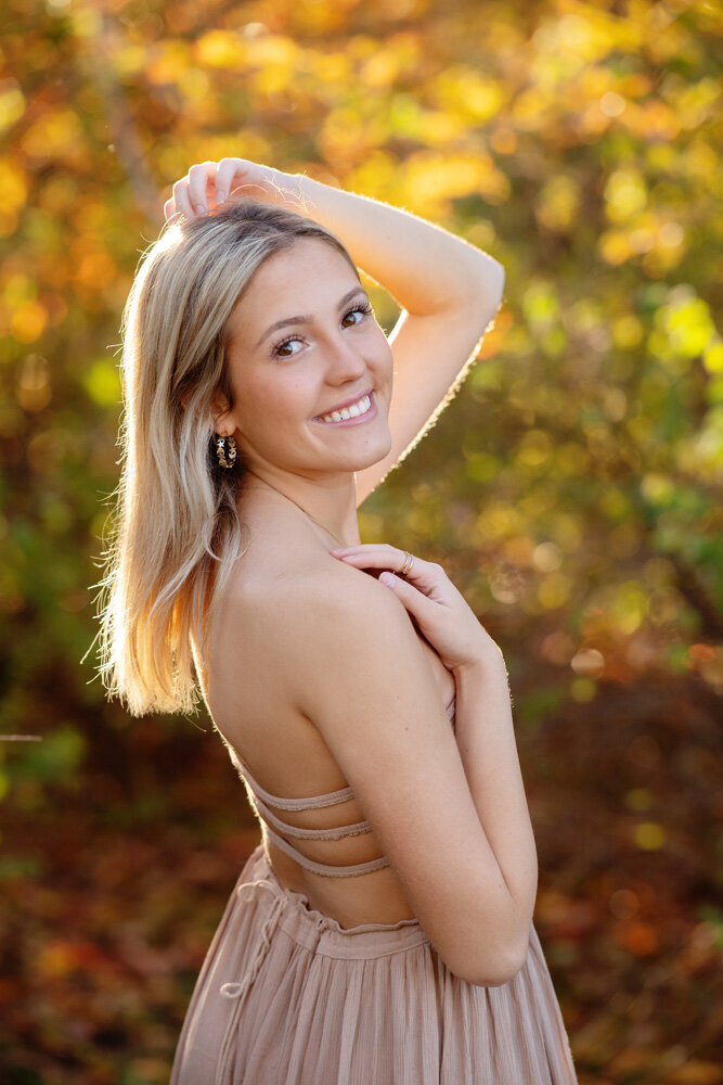 Senior session of young woman wearing a dress outside