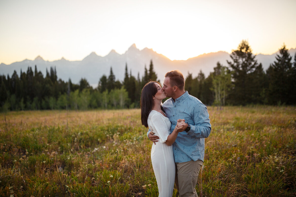 bride and groom slow dancing in front of the grand tetons