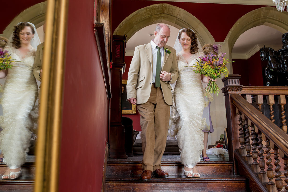 Bride and Dad walking to ceremony at Huntsham Court Devon