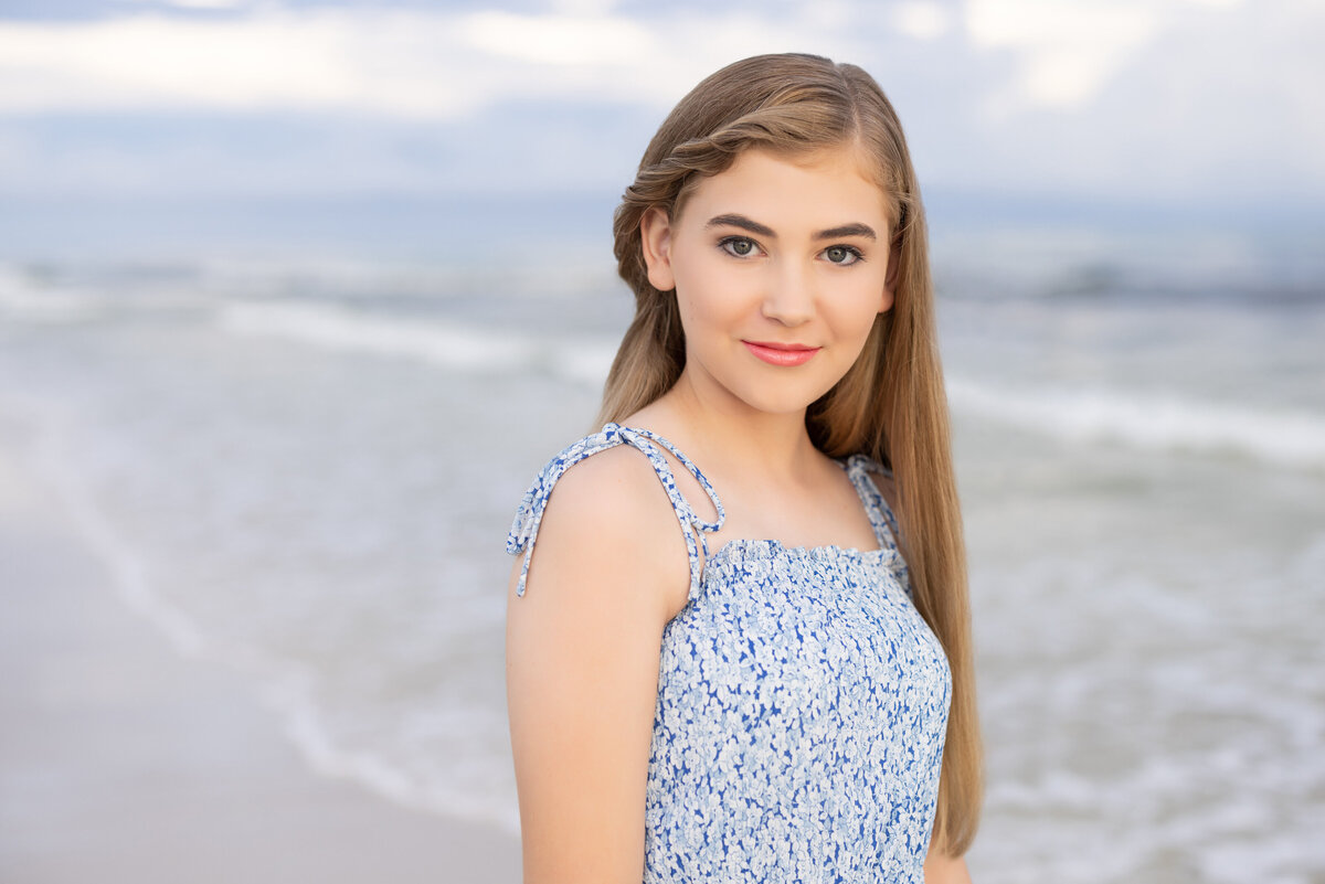 A young girl smiling at the beach