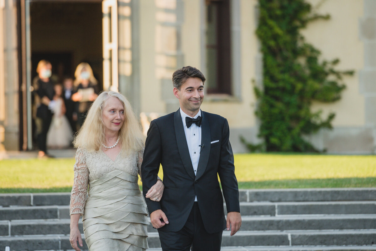 groom and mother walking down the aisle at Oheka Castle
