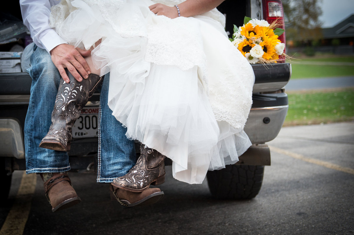 bride wears cowboy boots under dress-foot photo