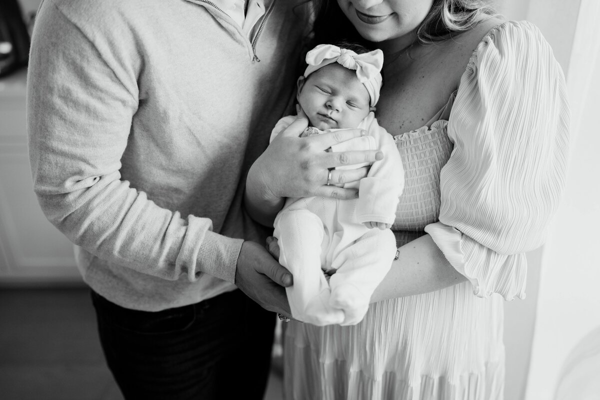 Mother and father holding newborn