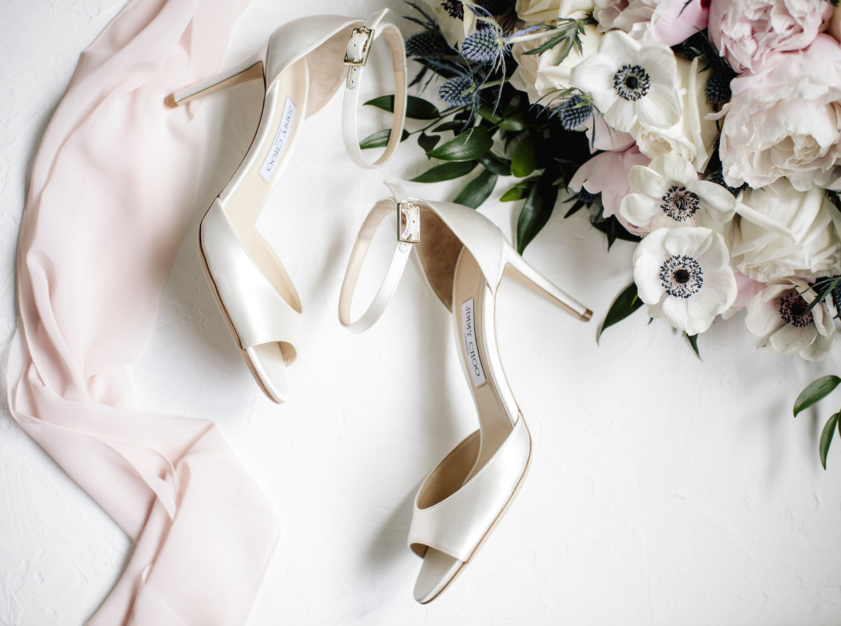 wedding shoes next to flowrs