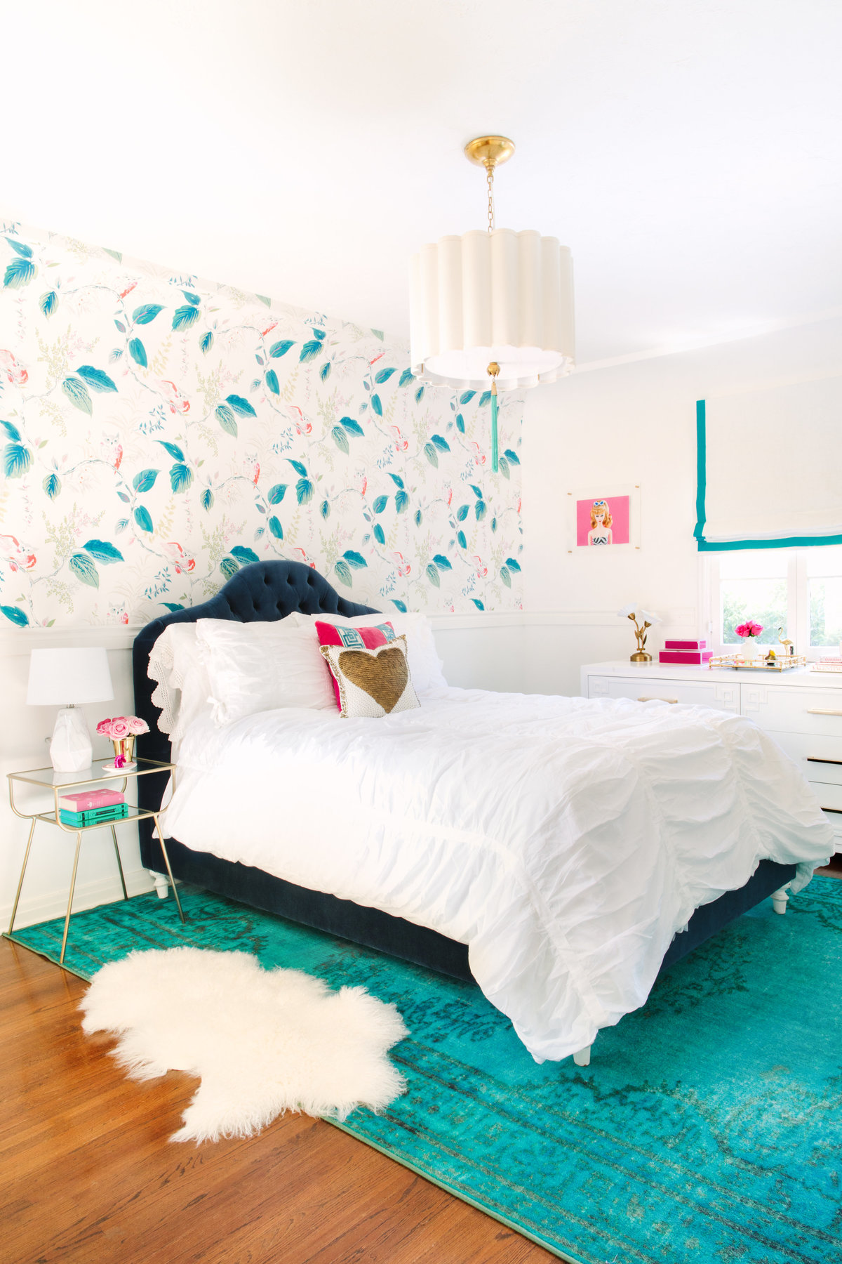 Bedroom with Kate Spade Owlish wallpaper, navy velvet bed, and teal rug