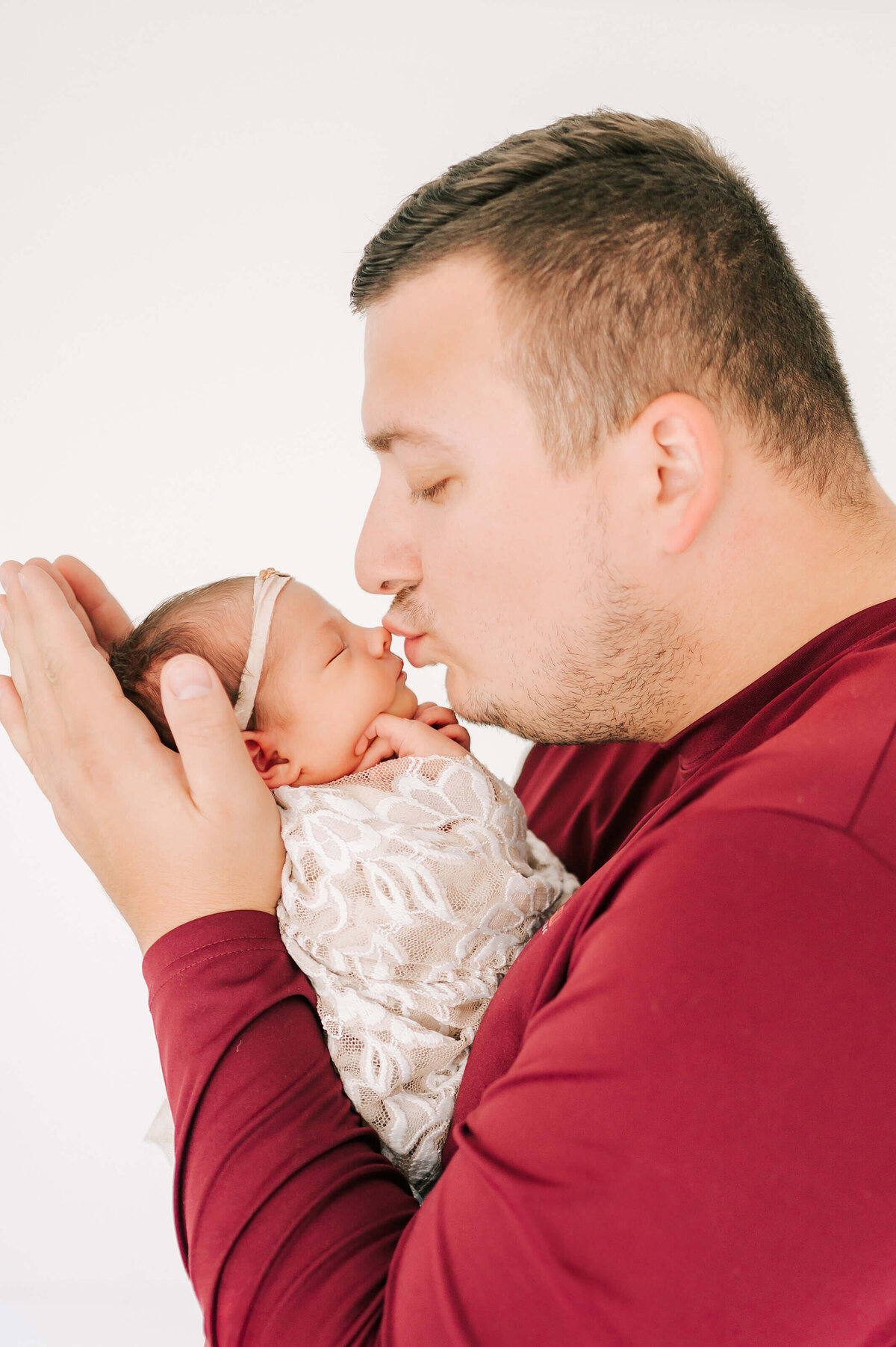 newborn pictures in Springfield MO of dad kissing newborn baby nose