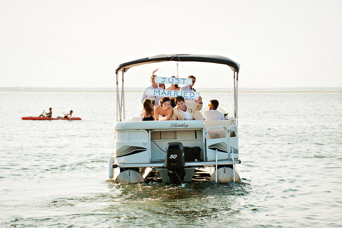 A newly married couple hop a boat after the ceremony on Long Beach Island, NJ.
