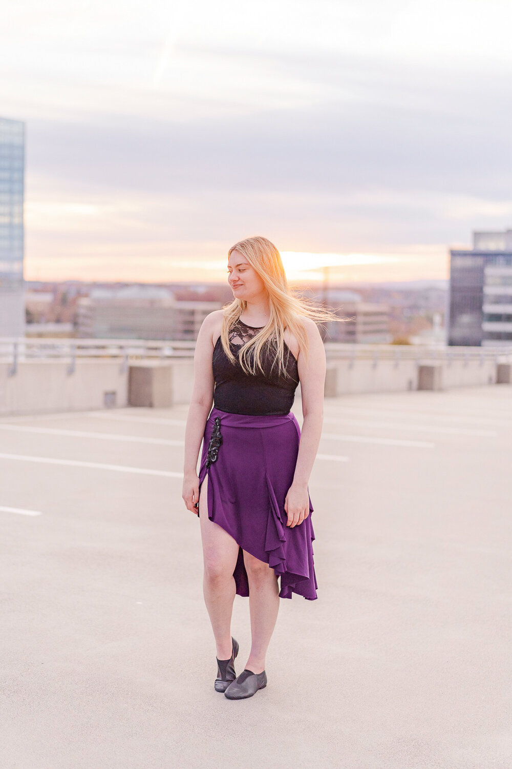 girl looking away at a parking garage during senior pictures in Vienna, Virginia
