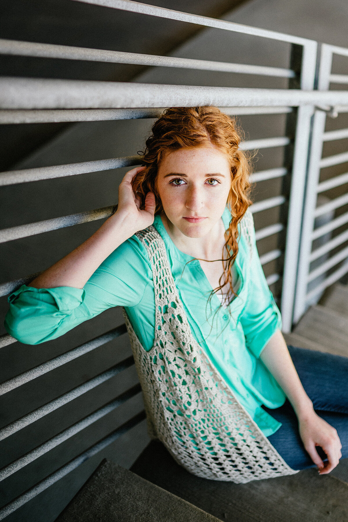 a senior girl poses in a parking garage in des moines