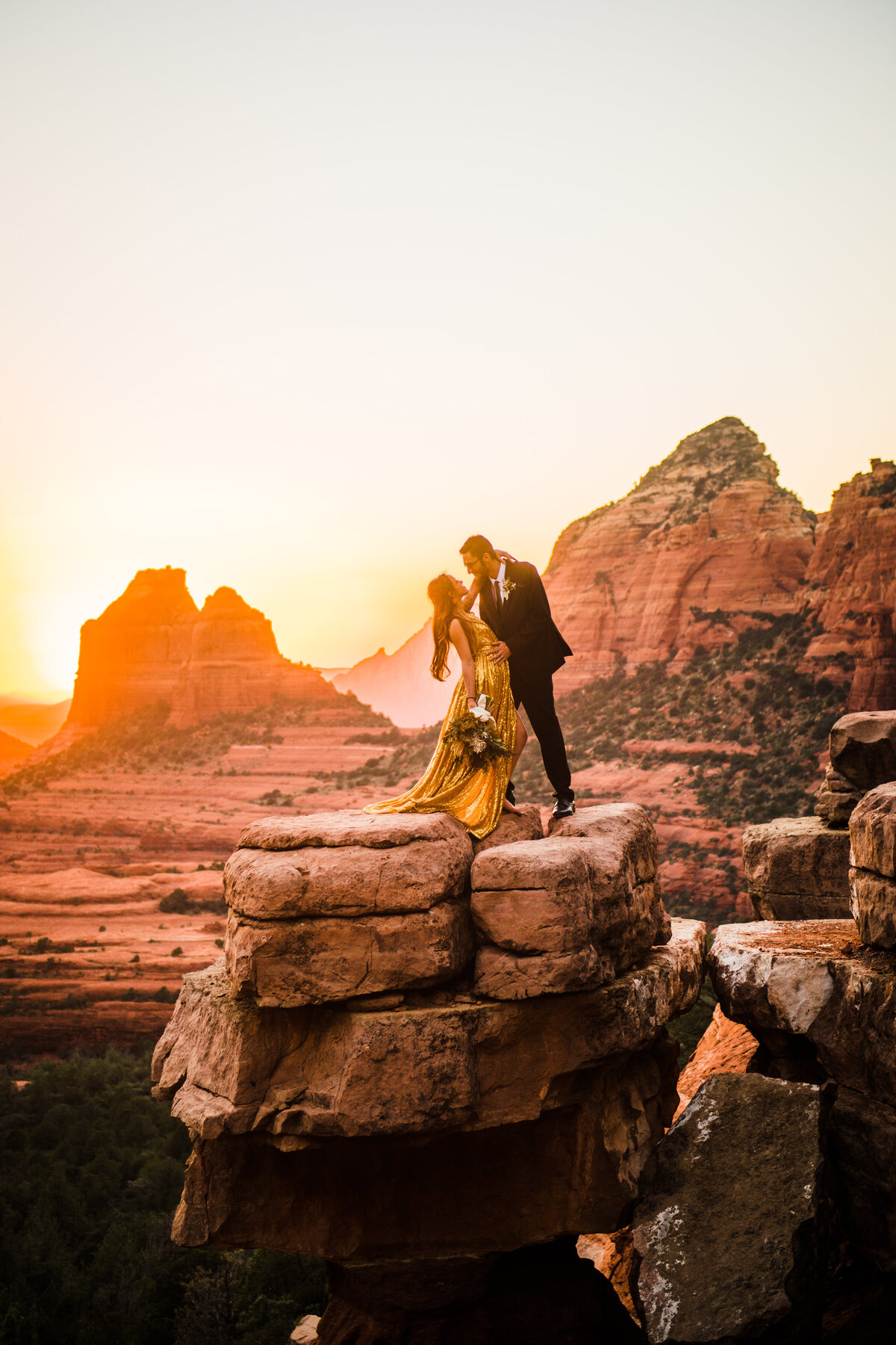 engaged couple golden hour dip on red rocks Merry Go Round Rock Sedona elopement photography engagement
