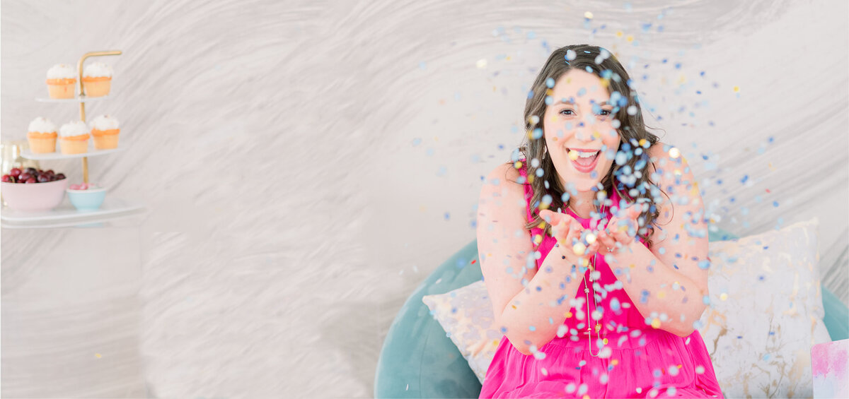 Isabel Kateman in a pink dress celebrating a client's website launch with confetti
