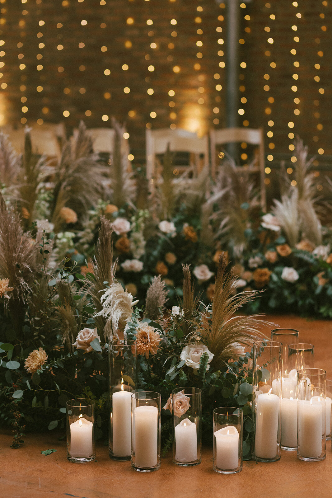 Pampas grass, eucalyptus and roses in abundant display at wedding ceremony at Loft on Lake, Chicago.