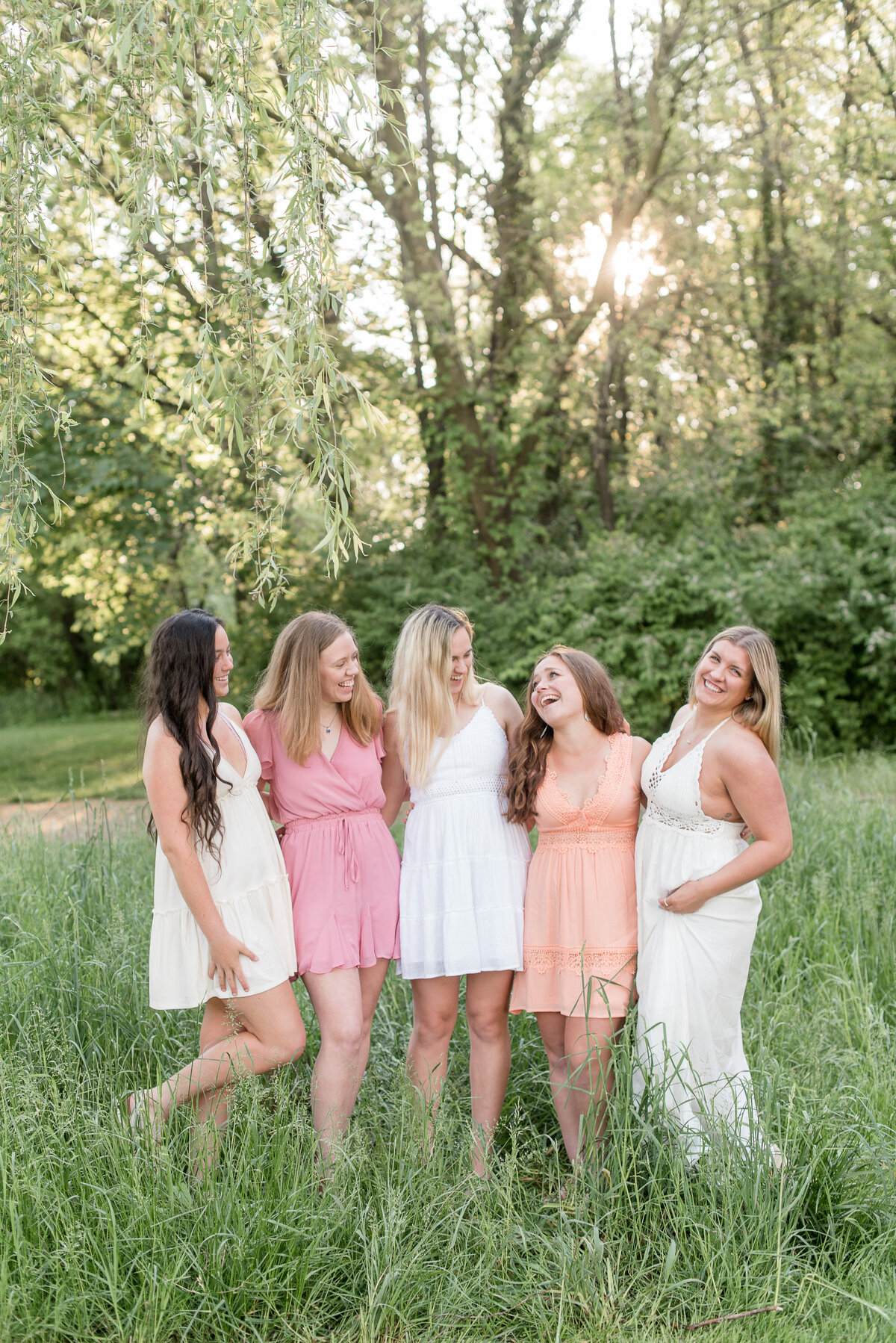 Five Senior girls with arms around each other smiling and looking in different directions at Lancaster County Park.
